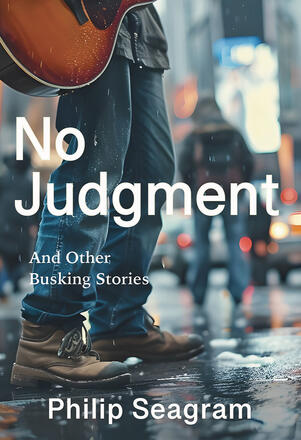 No judgement and other busking stories book cover with a a man standing in the street wearing work boots and jeans, holding a guitar.